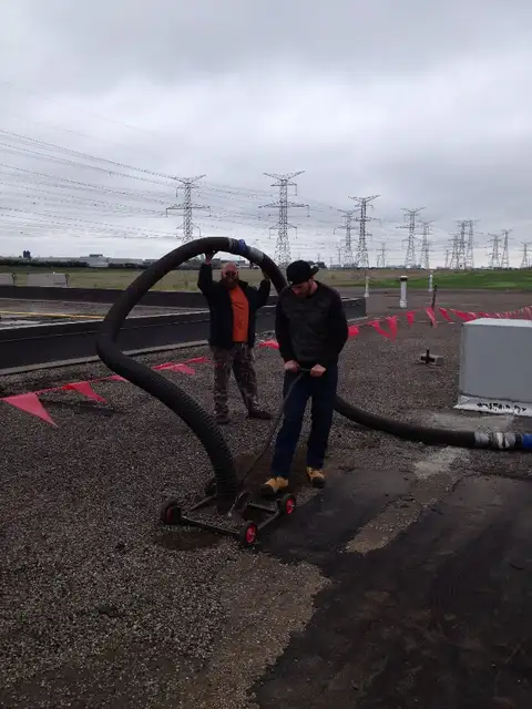 Gravel is removed by industrial roof vacuum